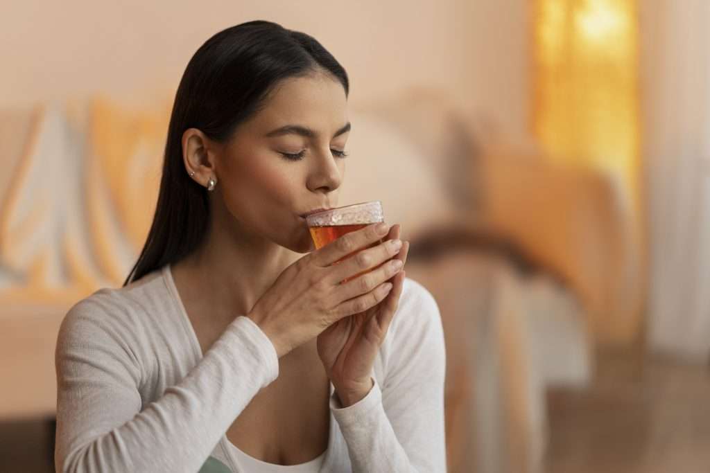 Woman holding a cup of Pure & Easy Tea
