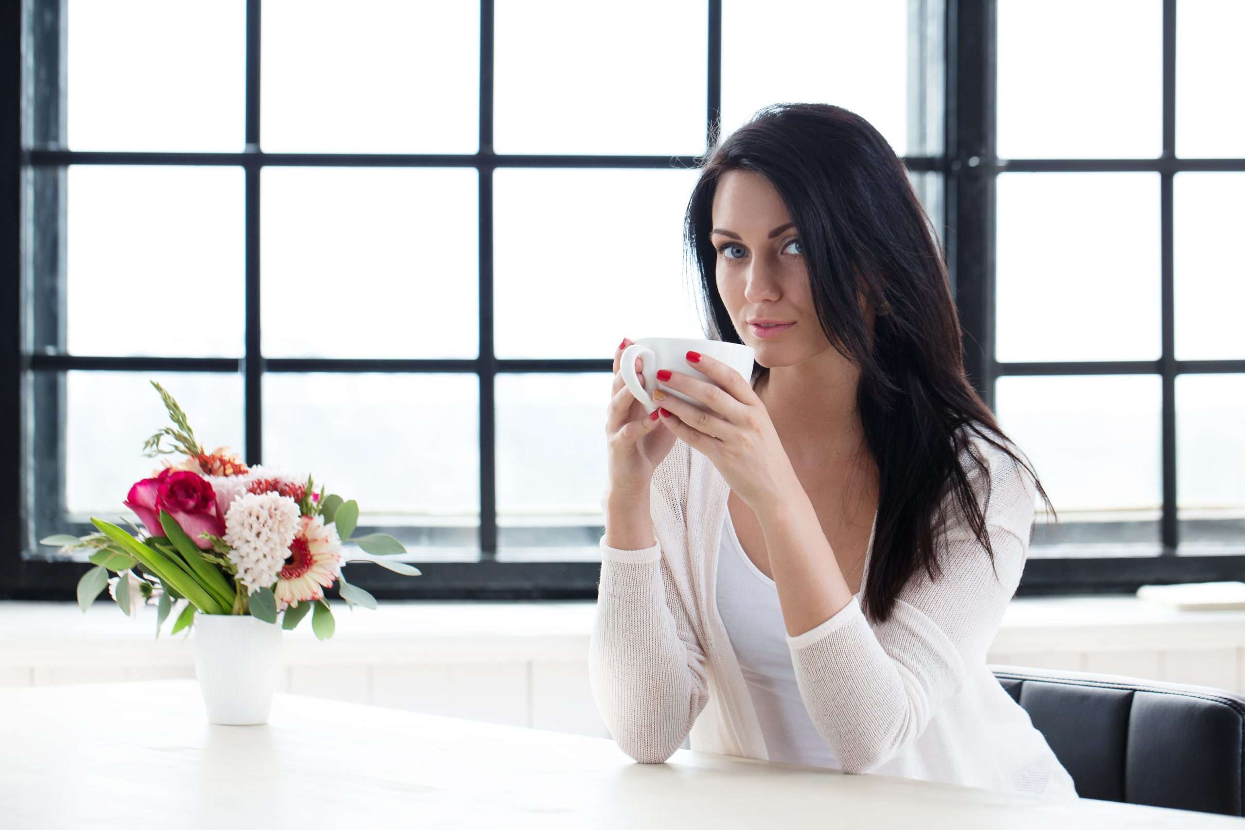 Woman enjoying a quiet detox tea ritual, one steady cup at a time