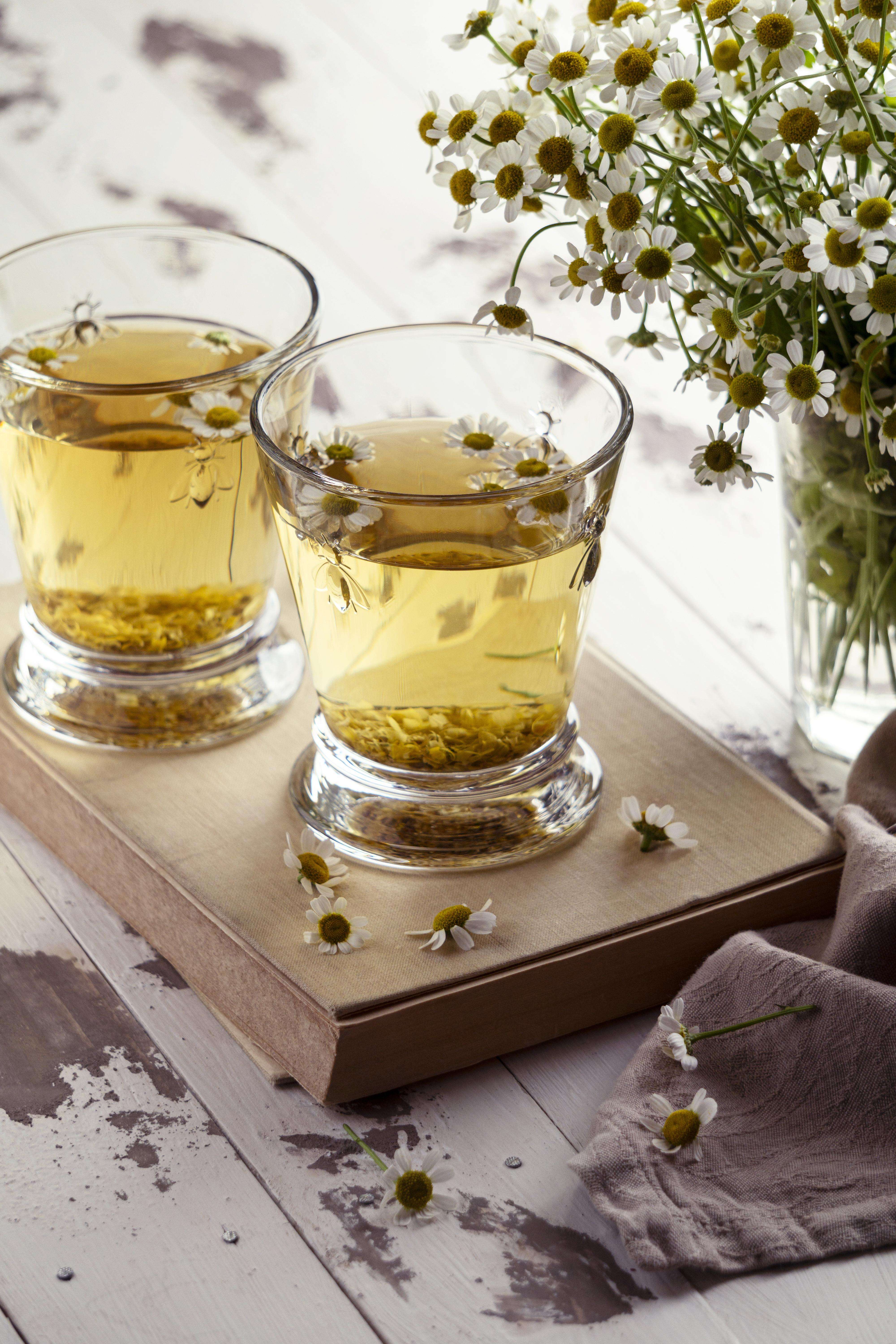 Chamomile tea cups on a wooden board
