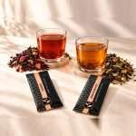 Sunrise and EnduraBoost brewed in glasses beside their loose-leaf blends and Pure Tea Experience pouches