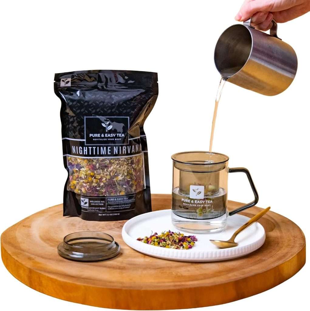 Hot water poured into the glass tea infuser mug beside a pouch of Nighttime Nirvana loose leaf