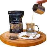 Hot water poured into the Pure & Easy Tea glass infuser mug beside a pouch of Nighttime Nirvana loose-leaf tea