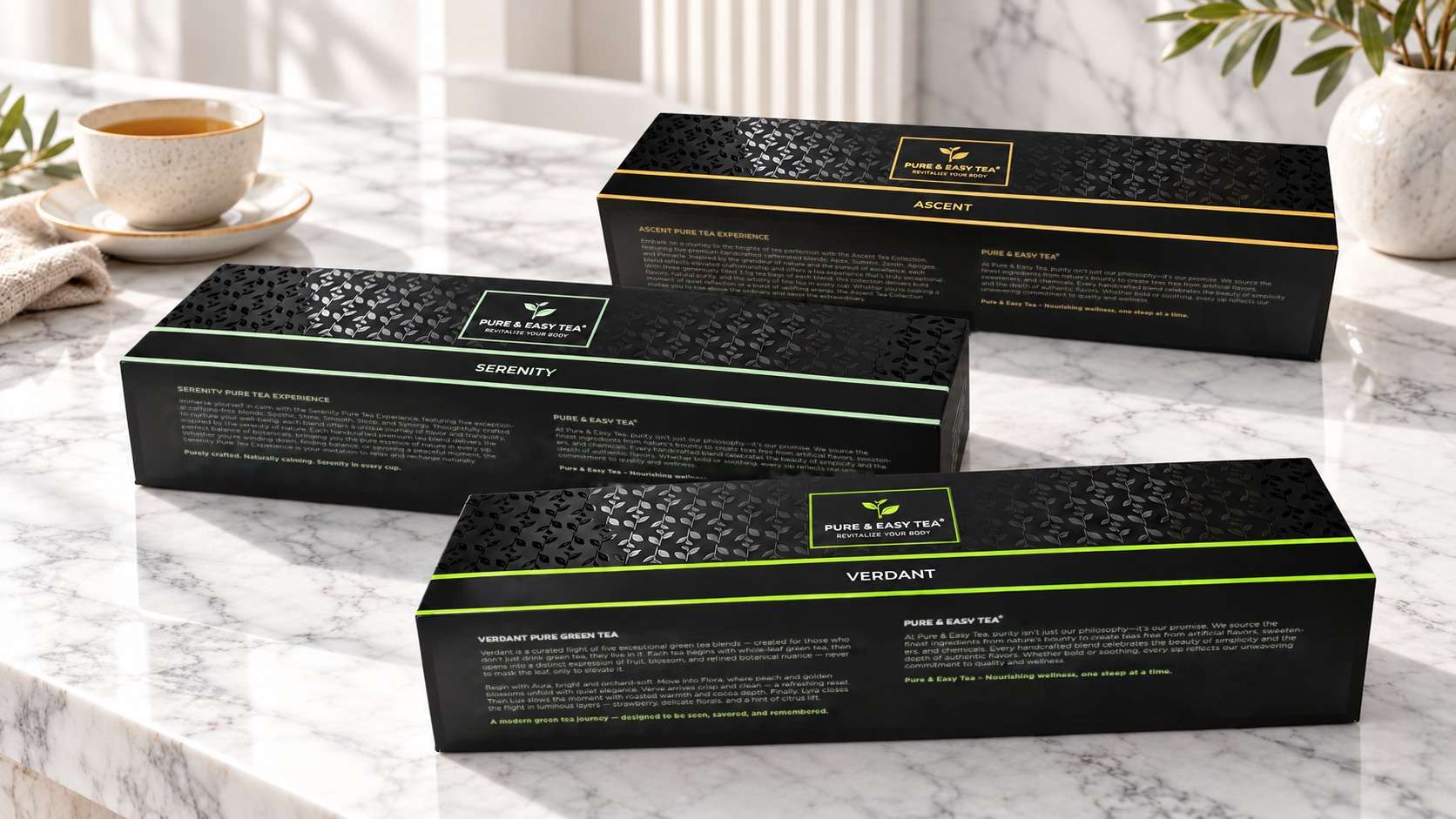Tea flights: the Ascent, Serenity and Verdant boxes on a marble counter beside a cup of tea