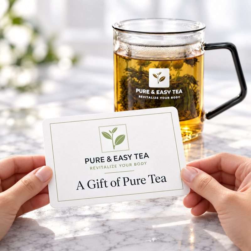 Pure & Easy Tea gift card reading A Gift of Pure Tea, held in front of a glass infuser mug of brewed tea