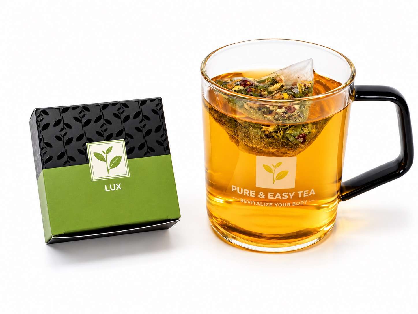 Pyramid tea sachet of whole botanicals steeping in a glass mug beside the Lux box from the Verdant green tea flight